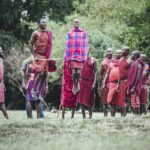 How do Maasai guides at Angama Mara enrich the walking safari experience?