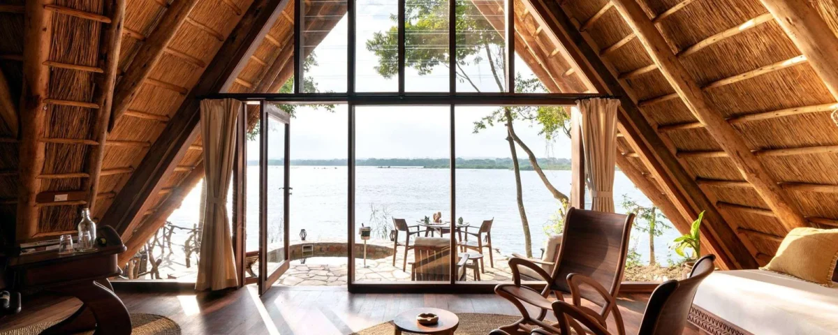 How Does the Design of Clouds Lodge Incorporate Local Volcanic Stone and Ugandan Artwork?