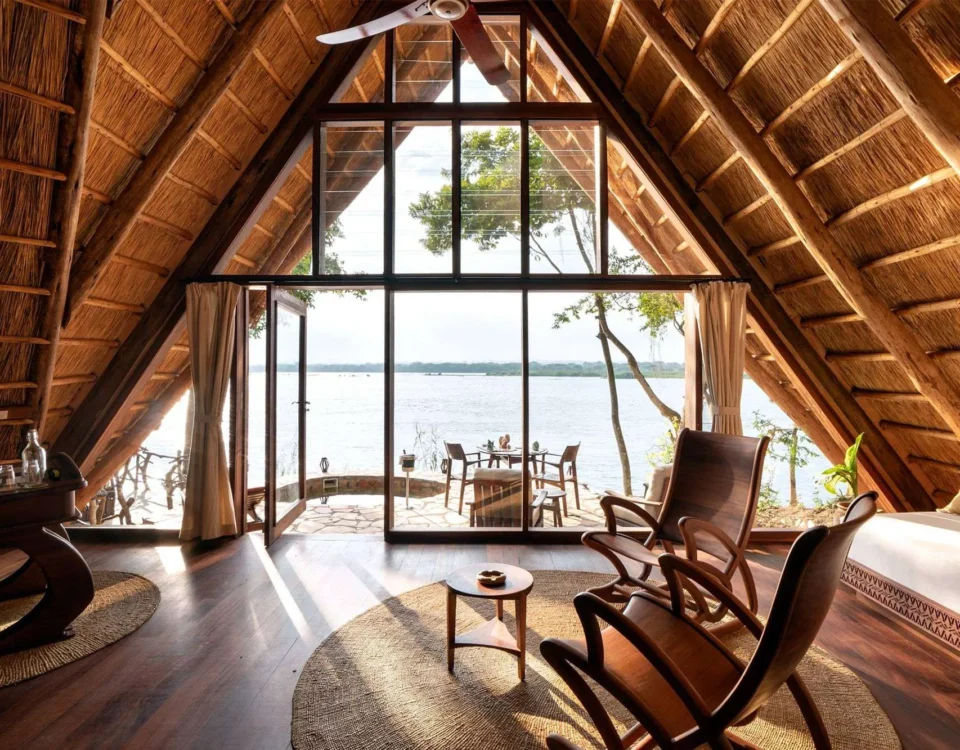 How Does the Design of Clouds Lodge Incorporate Local Volcanic Stone and Ugandan Artwork?